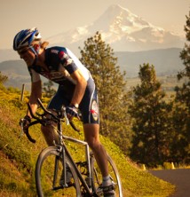 Mountain biker on country road with Mt. Hood in background