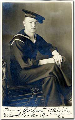 Lewis Keith in Navy uniform sitting on chair.