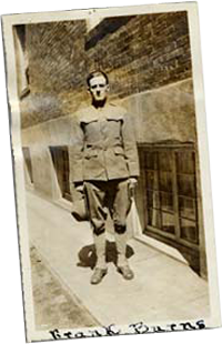 Frank Burns stands on street corner wearing his uniform.