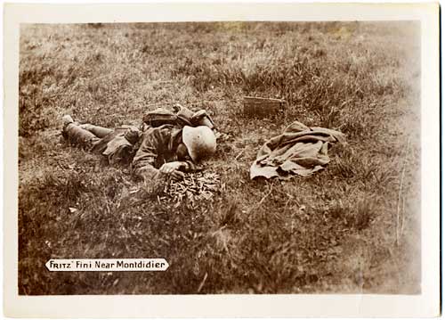 German soldier lies face down, dead, in a field.