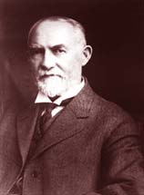 Gov. James Withycombe: A gray bearded man in suit and tie.