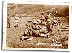 Soldiers practice with machine guns on a field.