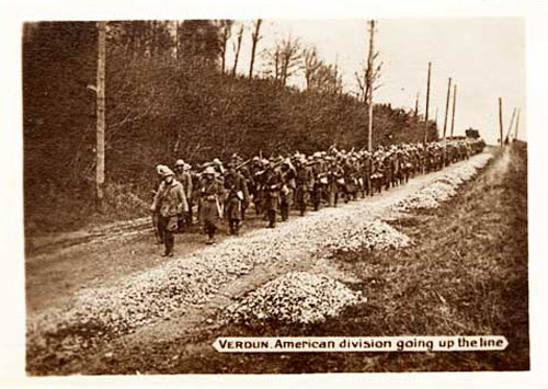 American soldiers march down a road.