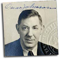 Photograph of Oscar Johnson in a suit. His signature in blue ink across the top.