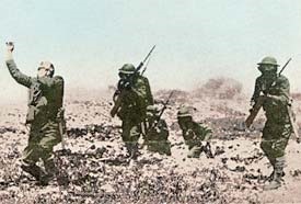 4 soldiers on the battlefield carrying guns.