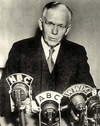Photo of George C. Marshall in suit & tie speaking in front of news microphones. The microphones are each labeld: NBC, ABC, WWDC