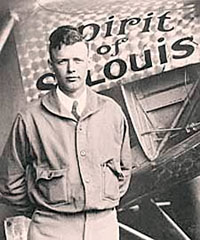 Photo of Charles Lindbergh standing in front of airplane.