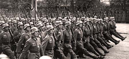 German soldiers marching in lines with legs kicked high when stepping.