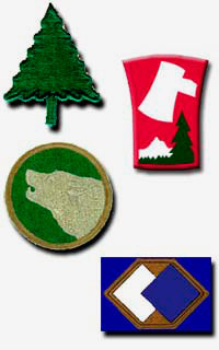 Patches in shape of evergreen tree, oval with a wolf profile, 1 shape of a stump with an ax & a tree, 1 with hexagon and squares
