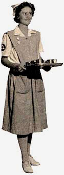 Woman dressed in nurse's aide uniform holding a tray with dishware.