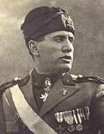 Benito Mussolini in his military formal wear with many medals pinned to the front.