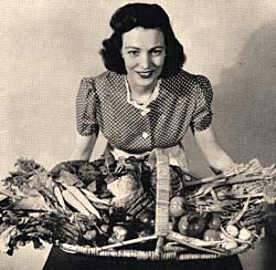 Photo of woman holding basket of vegtables. 