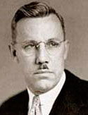 Photo of Conde McCullough wearing suit, tie and glasses.