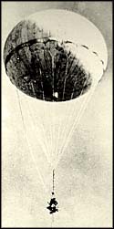 Photograph of balloon with bomb floating through air.
