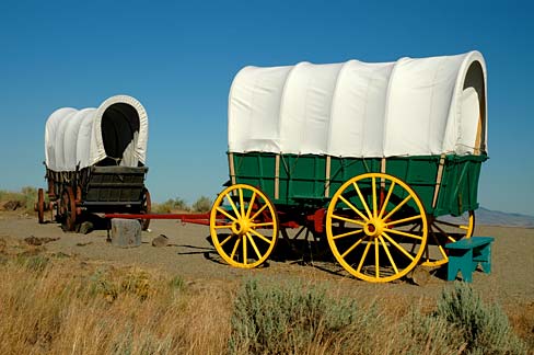 2 replica covered wagons outside on display.