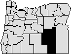 Map of Oregon with section in south eastern area blacked out to represent Harney County.