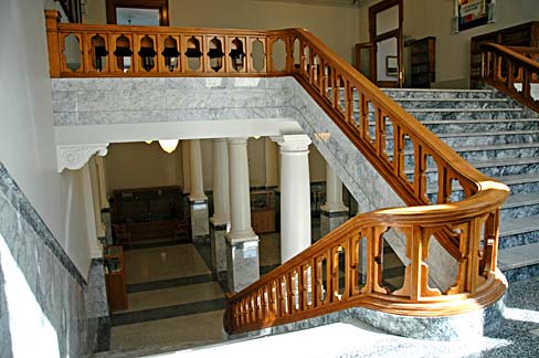 Marble staircase with wood railing in Wasco courthouse.