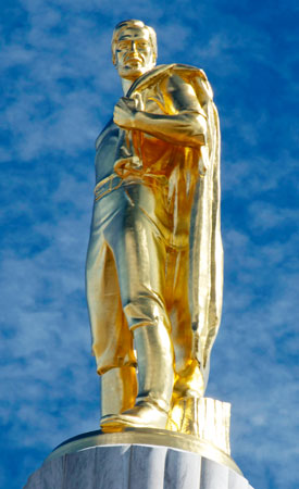 Statue covered in gold leaf of a pioneer man looking out over the horizon.