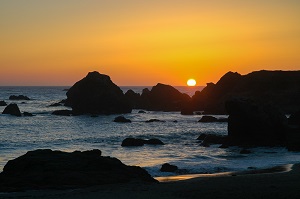 Rocky beach line with sunset.