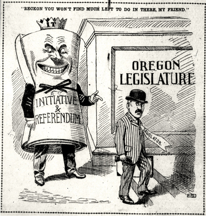 A cartoon of Initiative & Referendum with arms and legs and a smiling face points at a man walking into the Oregon Legislature.