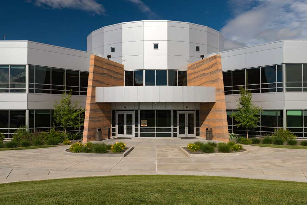 A modern tribal government building with contemporary architectural lines, two story building with floor to ceiling windows on each level.