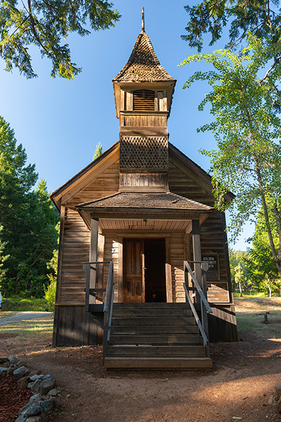 One-story, wood-frame building rectangular shape. Belfry finished with diamond-shaped shingles. Stair lead to entrance landing.