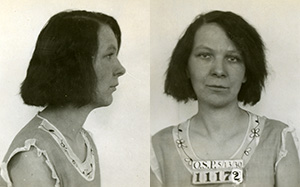 Mug shot of Katherine Hicks in a sleeveless dress with flower pattern around collar and prisoner number 11172