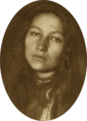Photo of young Native American woman with long dark hair.