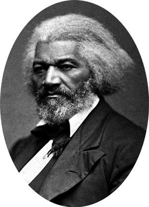 Photo of Frederick Douglass in a suit and tie. His hair is gray & cut just below ear length.