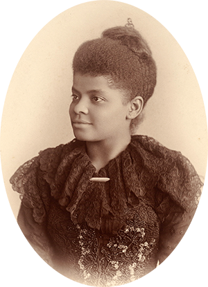 Photo of Ida B. Wells-Barnett in a lacy black dress. Her hair is pinned up behind her head.