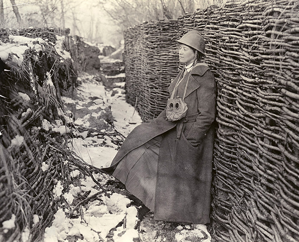 Photo of Helen Johns standing in a trench. There is snow on the ground.