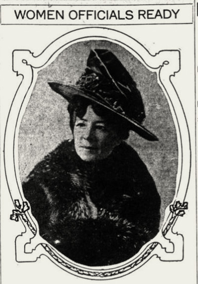 Photo of a woman in a fur coat with a brimmed hat. Over her picture it says: Women Officials Ready 
