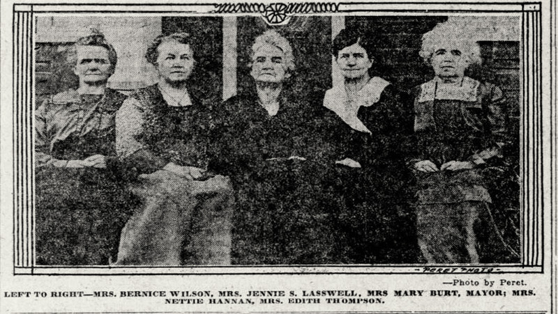 Photo of 5 women standing before a brick wall.