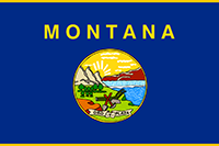 Montana flag has the state seal showing a sunrise over snowy mountains, waterfalls, a river, mountains, hills, trees and cliffs. A pick, shovel and plow rest on the ground.