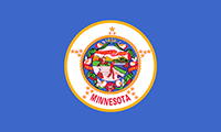 Minnesota flag has the state seal on a royal blue background. Three dates are woven in a wreath surrounding the seal: 1858, 1819, and 1893.