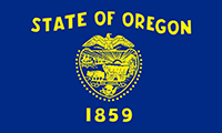 Oregon flag has the state seal in gold with State of Oregon written over top and the year 1859 below. The background is blue.