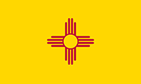 New Mexico flag has a center design of the ancient Zia sun symbol in red. The background is yellow.