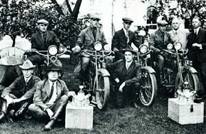 Nine men of the state traffic division pose with motorcycles.