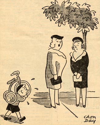 A boy carries a trike on his shoulder. Two women stand under a tree and talk.