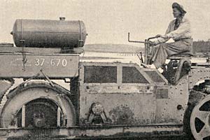 Photo of a woman driving road building equipment.