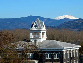 Rooftop view of courthouse with bell tower and Mt. St. Helens in the background.