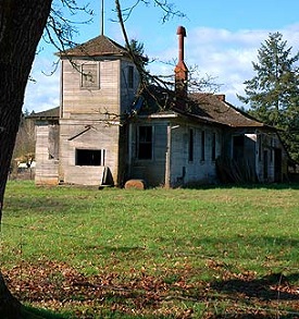 Small one-room schoolhouse with a gabled roof, sits close to Scholls Ferry Road in rural Washington County, Oregon.