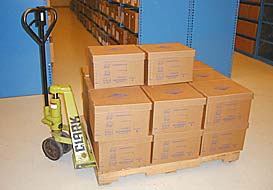 A pallet and jack with 14 cardboard boxes stacked on top.
