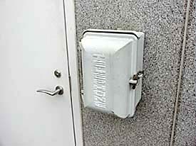 View of the call box mounted on the wall to the side of a door.