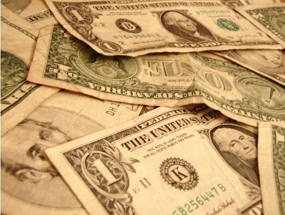 Dollar bills in a pile