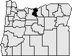 Map of the state of Oregon with Sherman county in the north middle of the state blacked out.