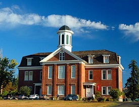 Benton County Museum is a 3 story brick building with bell tower at center.