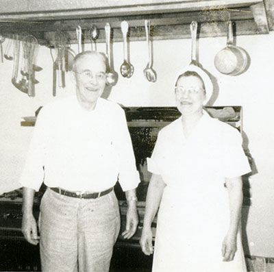 Two people stand in the Chef's Inn kitchen