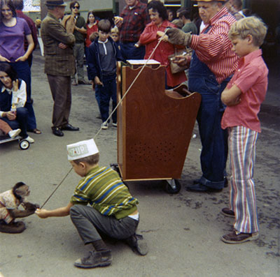 A boy and a monkey entertain the crowd