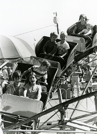 Children ride a roller coaster